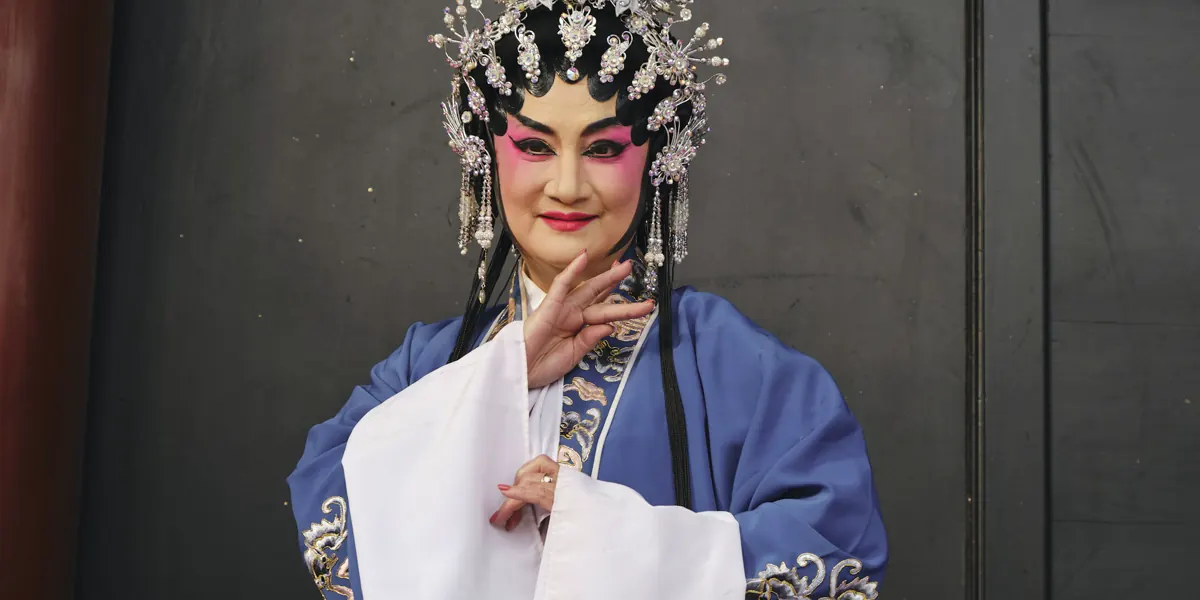 A Chinese opera performer in traditional makeup and headdress
